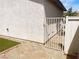 Fenced side yard with artificial grass and a gate, offering private outdoor space at 9073 Spoonbill Ridge Pl, Las Vegas, NV 89143