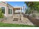 Landscaped backyard featuring a hot tub and covered patio, perfect for relaxation and outdoor entertainment at 9211 Golden Feather Ct, Las Vegas, NV 89147