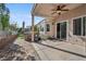 Inviting backyard patio with a ceiling fan, a built in spa, and well-maintained pavers at 9211 Golden Feather Ct, Las Vegas, NV 89147