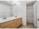 Bright bathroom featuring double sinks, wood cabinets, and a separate tub/shower at 9211 Golden Feather Ct, Las Vegas, NV 89147
