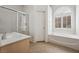 This bathroom features a sunken tub, glass enclosed shower, and a single vanity at 9211 Golden Feather Ct, Las Vegas, NV 89147