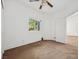 Bright and airy bedroom with carpet flooring, window, and a ceiling fan at 9211 Golden Feather Ct, Las Vegas, NV 89147