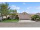 Charming single-story home featuring a two-car garage and well-maintained front yard at 9211 Golden Feather Ct, Las Vegas, NV 89147