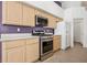 Modern kitchen with stainless steel appliances and light wood cabinets at 9211 Golden Feather Ct, Las Vegas, NV 89147