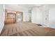 Spacious living room featuring carpet and a decorative bar area at 9211 Golden Feather Ct, Las Vegas, NV 89147