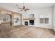 Spacious living room with fireplace, carpet flooring, ceiling fan and unique wall decor with plenty of natural light at 9211 Golden Feather Ct, Las Vegas, NV 89147