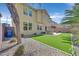 Spacious backyard with artificial turf, patio, custom grill, and manicured landscaping for outdoor living at 9221 Steeltree St, Las Vegas, NV 89143