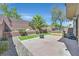 Serene backyard featuring custom grill and firepit, plus a patio, artificial grass, and privacy landscaping at 9221 Steeltree St, Las Vegas, NV 89143