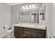 Bathroom with dual sinks, dark cabinets, shower, and modern lighting at 9221 Steeltree St, Las Vegas, NV 89143