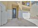 Inviting front entrance with a decorative oval glass door, a two-car garage, and a cozy balcony above at 9221 Steeltree St, Las Vegas, NV 89143