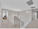 Upstairs hallway with white railing leads to bedrooms and living spaces at 9221 Steeltree St, Las Vegas, NV 89143
