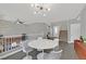 Spacious living area with modern chandelier, gray tiled floors, and neutral tones for a bright and airy feel at 9221 Steeltree St, Las Vegas, NV 89143