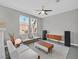 Upstairs living space with bright natural light from large windows and a stylish ceiling fan for a relaxed atmosphere at 9221 Steeltree St, Las Vegas, NV 89143