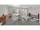 Open concept living and dining area with tile flooring, modern lighting, and bright windows offers stylish living at 9221 Steeltree St, Las Vegas, NV 89143