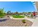 Expansive backyard featuring a playset, lush green lawn, and elegant landscaping at 9511 Star Vista Ct, Las Vegas, NV 89149