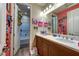 Well-lit bathroom featuring a double sink vanity and a shower-tub combination at 9511 Star Vista Ct, Las Vegas, NV 89149