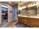 Bathroom features wood cabinets, granite countertops, double sinks, and an open doorway to a walk-in closet at 9511 Star Vista Ct, Las Vegas, NV 89149