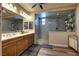 A spacious bathroom features a walk-in shower, granite countertops, and double sinks for added convenience at 9511 Star Vista Ct, Las Vegas, NV 89149