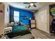 Cozy bedroom featuring a blue accent wall, closet space, and hardwood floors at 9511 Star Vista Ct, Las Vegas, NV 89149