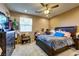 Relaxing bedroom with ceiling fan, window and carpet at 9511 Star Vista Ct, Las Vegas, NV 89149