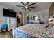 Spacious bedroom featuring a ceiling fan, TV, and drawers for ample storage at 9511 Star Vista Ct, Las Vegas, NV 89149