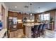 Well-lit kitchen featuring granite countertops, stainless steel appliances, a spacious island and bar stool seating at 9511 Star Vista Ct, Las Vegas, NV 89149