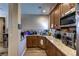 Eat-in kitchen features granite counters, tile backsplash, updated appliances and wood cabinets at 9511 Star Vista Ct, Las Vegas, NV 89149