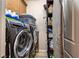 Convenient laundry room boasts gray front load washer and dryer and shelving at 9511 Star Vista Ct, Las Vegas, NV 89149