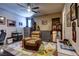 Cozy living room boasts a plush recliner, colorful rug, display cabinets, and large windows for natural light at 9511 Star Vista Ct, Las Vegas, NV 89149