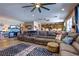 Expansive living area with a large sectional sofa, hardwood floors, and an open kitchen layout at 9511 Star Vista Ct, Las Vegas, NV 89149