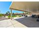Large covered patio with ample space for outdoor dining and relaxation, overlooking a well-manicured backyard at 9511 Star Vista Ct, Las Vegas, NV 89149