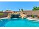 Close up of gorgeous pool featuring a rock waterfall and slide on a sunny day at 9511 Star Vista Ct, Las Vegas, NV 89149