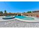 Beautiful pool with a water slide, waterfall features, and a relaxing spa surrounded by a stone patio at 9511 Star Vista Ct, Las Vegas, NV 89149
