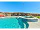 A backyard pool, hot tub, and patio area offer an oasis for relaxation and entertaining at 9511 Star Vista Ct, Las Vegas, NV 89149