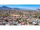 Extensive aerial view of a suburban neighborhood, displaying lush green landscapes and mountain vistas at 9536 Ruby Hills Dr, Las Vegas, NV 89134