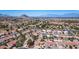 Expansive aerial view of a residential neighborhood surrounded by lush greenery and majestic mountains at 9536 Ruby Hills Dr, Las Vegas, NV 89134