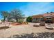 Backyard featuring mature trees, desert landscaping, a fire pit, and a hammock at 9536 Ruby Hills Dr, Las Vegas, NV 89134