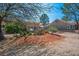 A shady backyard is showcased with desert landscaping and mature trees at 9536 Ruby Hills Dr, Las Vegas, NV 89134
