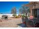 Outdoor patio with dining set, fireplace, hammock, and desert landscaping at 9536 Ruby Hills Dr, Las Vegas, NV 89134