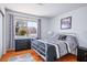 Bright bedroom with a large window, black dresser, and grey accents at 9536 Ruby Hills Dr, Las Vegas, NV 89134