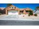 Single-story home with a two-car garage, desert landscaping, and a charming front entrance at 9536 Ruby Hills Dr, Las Vegas, NV 89134