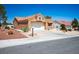 Single-story home with a two-car garage, desert landscaping, and a mailbox at 9536 Ruby Hills Dr, Las Vegas, NV 89134