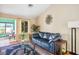 Bright living room with plush blue sofa, large window, and decorative sunburst wall decor at 9536 Ruby Hills Dr, Las Vegas, NV 89134