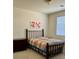 Cozy bedroom featuring carpeted floors, natural light from a window, and red flower art at 10516 Angel Dreams Ave, Las Vegas, NV 89144
