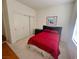 Bright bedroom with carpeted floors, a closet, and a bed with red linens at 10516 Angel Dreams Ave, Las Vegas, NV 89144