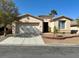 Charming single-story home boasts a well-maintained front yard and a welcoming facade at 10516 Angel Dreams Ave, Las Vegas, NV 89144