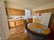 Eat-in kitchen boasts wood cabinets, white countertops, and stainless steel appliances at 10516 Angel Dreams Ave, Las Vegas, NV 89144