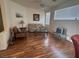 Bright living room with wood floors, neutral sofa, and ceiling fan at 10516 Angel Dreams Ave, Las Vegas, NV 89144