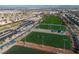This aerial photo shows sports fields in the city, with mountains in the background, and parking in the foreground at 1100 Meridian Bay Dr, Las Vegas, NV 89128