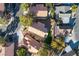 An aerial view reveals a Southwestern home with tile roof, desert landscaping and community streets at 1100 Meridian Bay Dr, Las Vegas, NV 89128